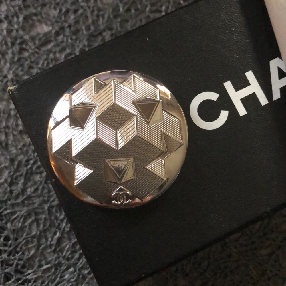 Silver pin made from a large button